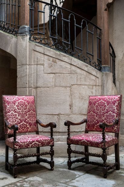 Pair of high armchairs in carved walnut with...