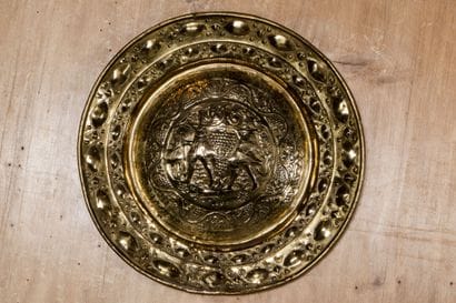Embossed brass offering dish decorated with...