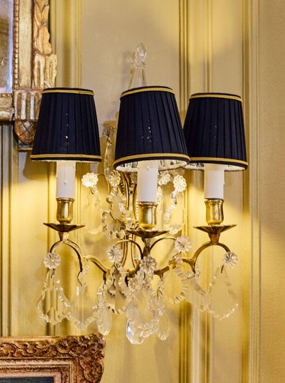 Pair of three-light gilt metal sconces adorned...