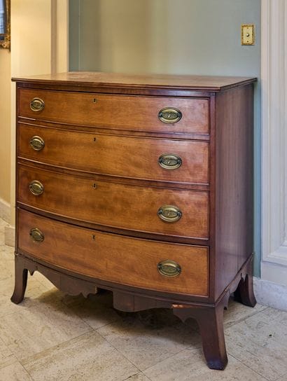 Natural wood chest of drawers opening in...