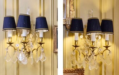 Pair of three-light gilt metal sconces adorned...