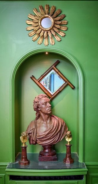 A patinated plaster bust of a man draped...