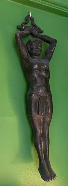 Sculpture of a man with hands tied above...