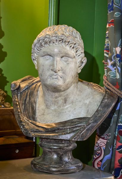 Bust on pedestal of a Roman emperor in plaster...