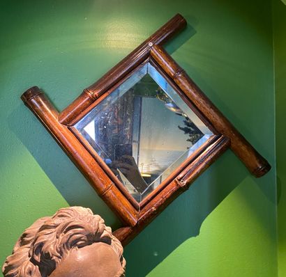 Beveled mirror in a bamboo frame. 
20th century....