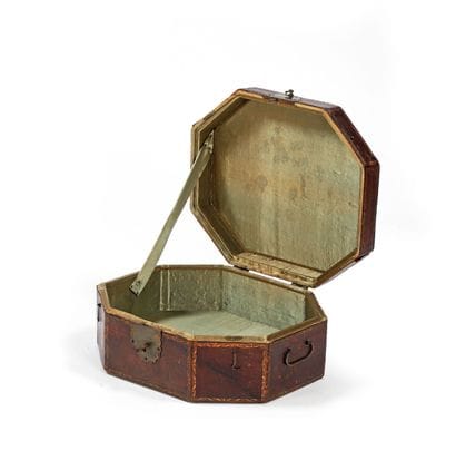 Octagonal wig box covered in red leather....