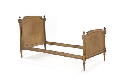 Bed frame made of carved wood with a cream...