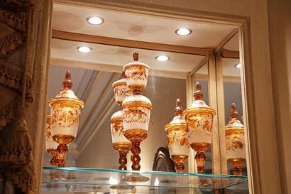 Pair of lidded vases on a multi-lobed pedestal,...