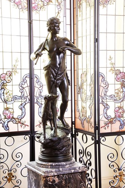 A patinated bronze sculpture depicting a...