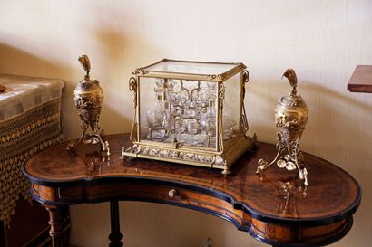 Glass and gilded bronze liquor cabinet containing...