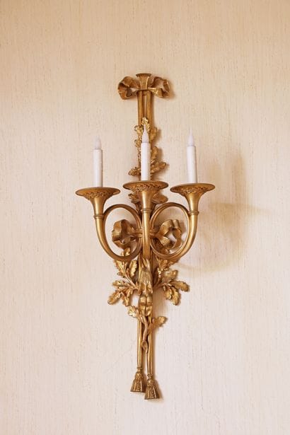 An important pair of gilded bronze wall sconces...
