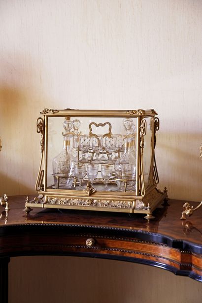 Glass and gilded bronze liquor cabinet containing...