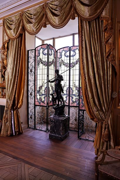 A patinated bronze sculpture depicting a...
