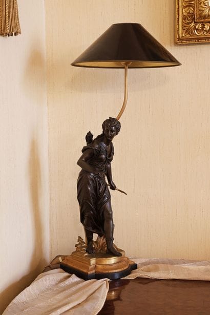 Patina-finished bronze sculpture depicting...