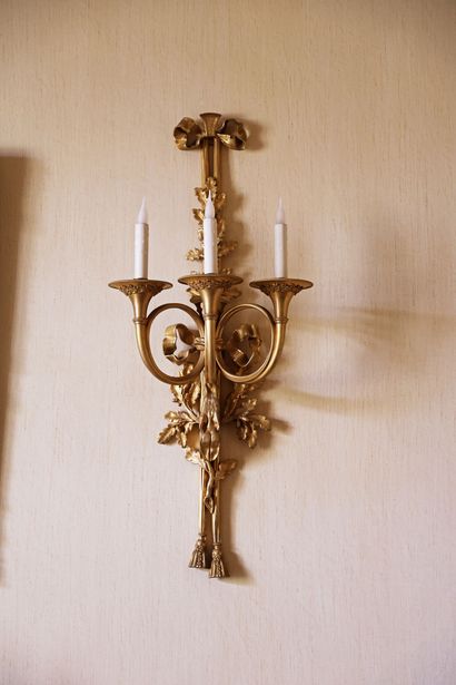 An important pair of gilded bronze wall sconces...