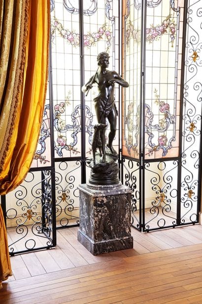 A patinated bronze sculpture depicting a...