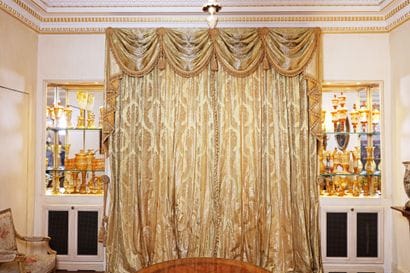 Pair of green silk curtains and a drapery...