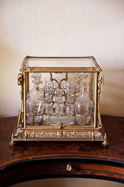 Glass and gilded bronze liquor cabinet containing...