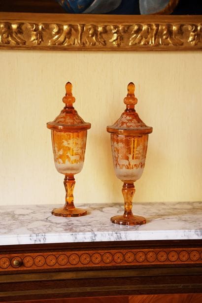 Pair of lidded vases on a multi-lobed pedestal,...
