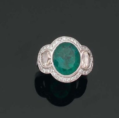 Bague ornée d'une émeraude ovale en sertissure...