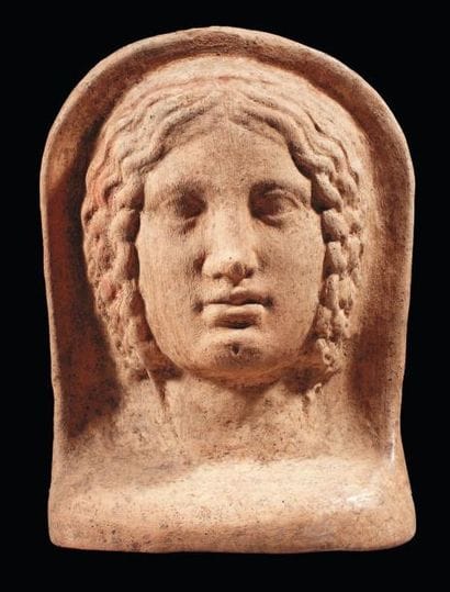 Tête votive représentant le visage d'une...