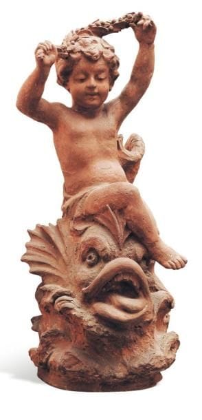 Putto sur un poisson sculpture en terre cuite....