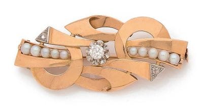 BROCHE en or 18K (750), formant des motifs...