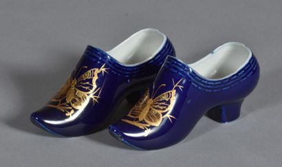 Pair of porcelain clogs with blue background...