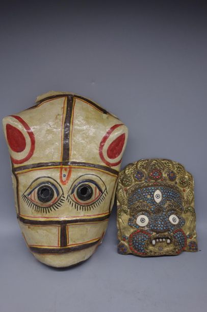 2 masks, the first in copper and beads, the...