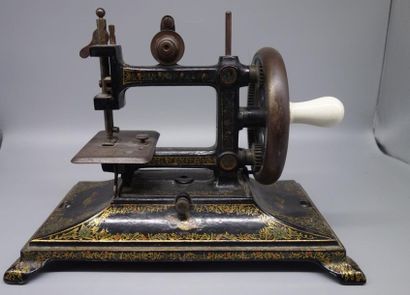 Old sewing machine made of cast iron with...