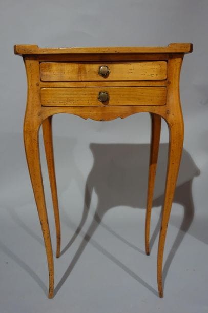 Small living room table in natural wood opening...