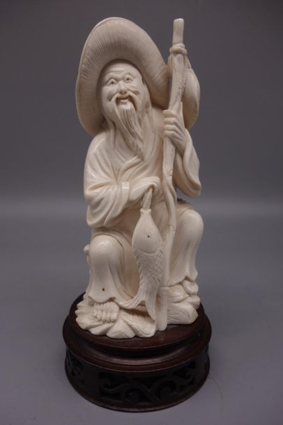 Ivory okimno depicting a seated fisherman...