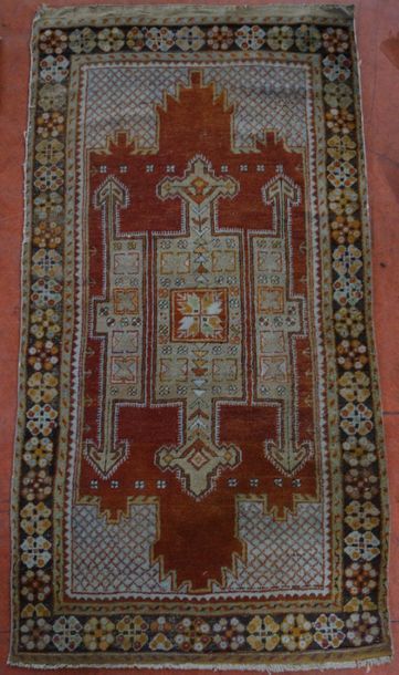 Knotted-stitch woollen rug decorated with...