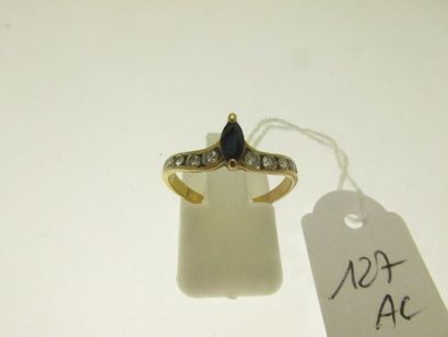 1 gold setting ring set with a small shuttle...