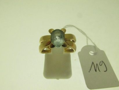 1 openworked gold ring set with a blue topaz...