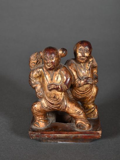 Carved wood group, gold lacquered, representing...