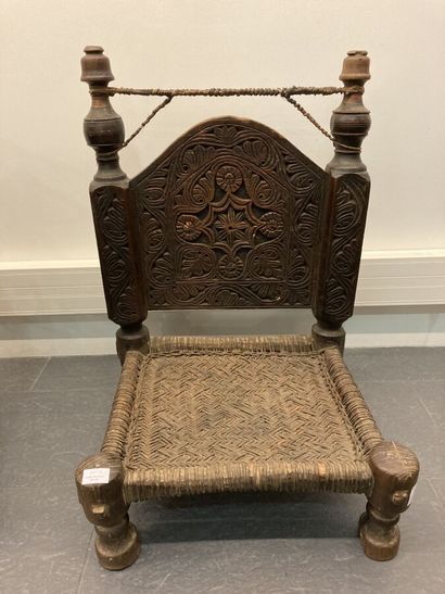 Set of two low chairs in carved wood, the...