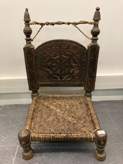 Set of two low chairs in carved wood, the...