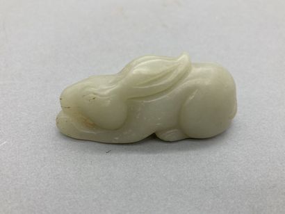 Two celadon jade pendants, one depicting...