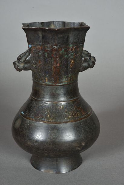 A bronze vase with a high flower-shaped neck,...
