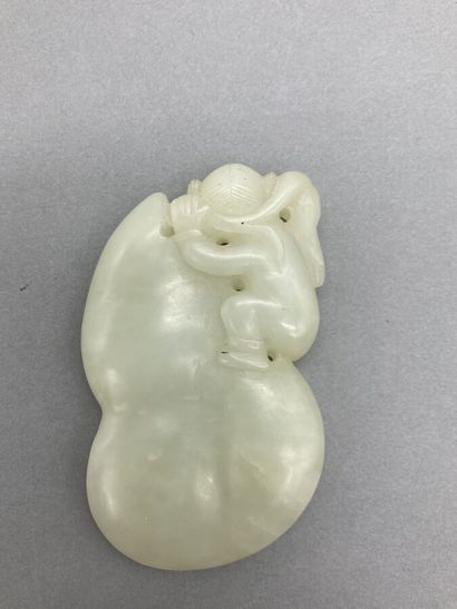 Two celadon jade pendants, one depicting...