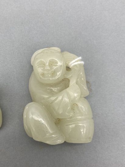 Two celadon jade subjects representing children,...