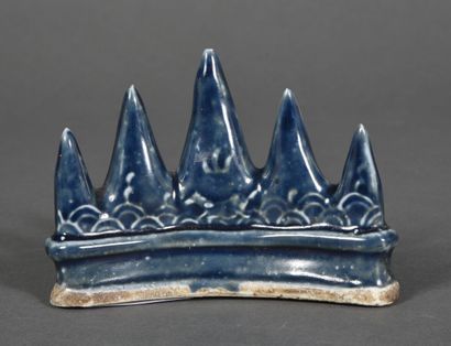 A midnight-blue enameled cookie brush rest,...