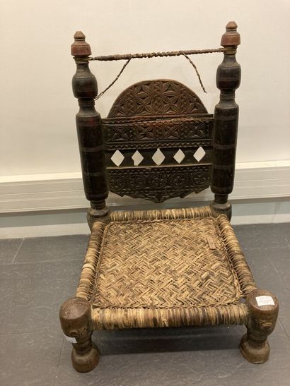 Set of two low chairs in carved wood, the...
