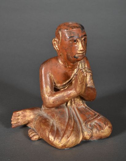 Gold lacquered wood subject on a brown-red...