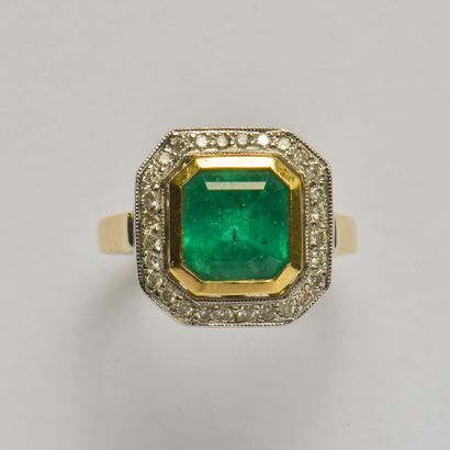 An 18K (750/oo) two-tone gold ring centered...