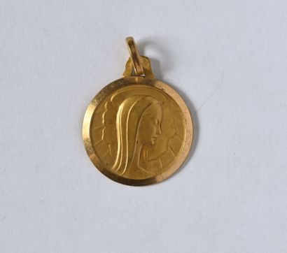 Round religious medal in 18K (750/oo) yellow...