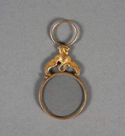 Petit monocle en or, support figurant un...