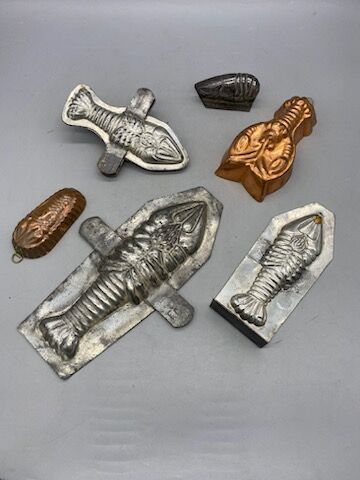 Six lobster-shaped tin or copper chocolate...