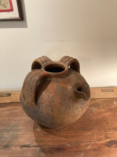 Small brown glazed earthenware jug with three...